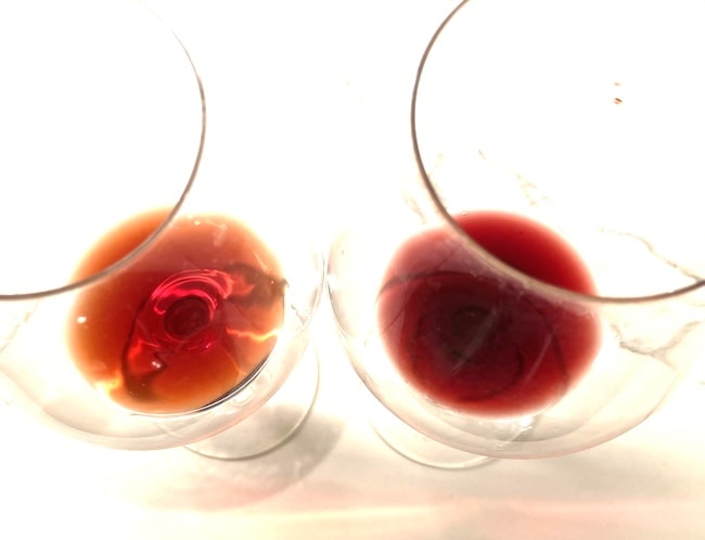 Two glasses of red wine with different shades of red