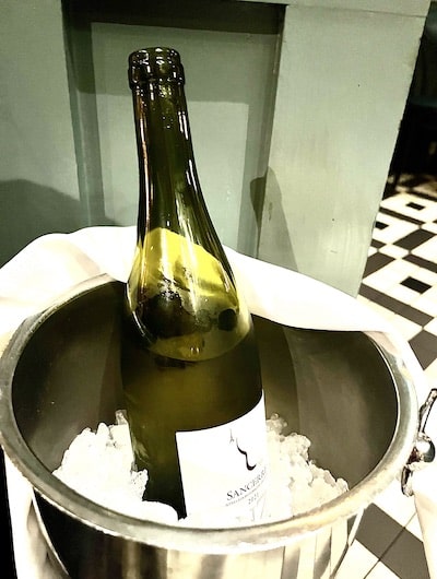 A bottle of Sancerre Sauvignon Blanc from France in an ice bucket